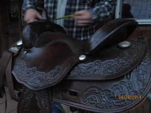 Angle close up view of brown leather horse saddle